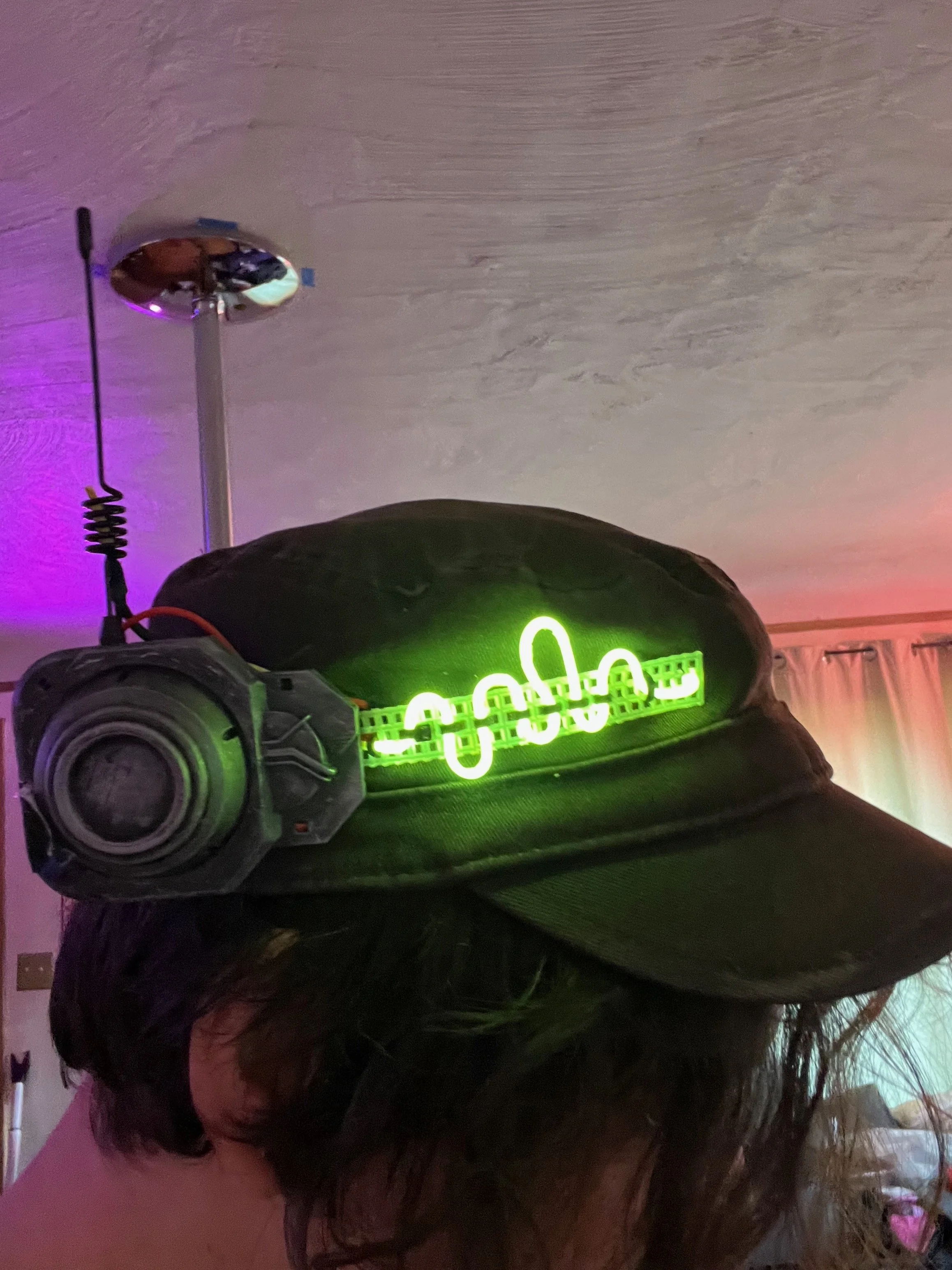 Neotropolis look — mechanic garb assembled from found pieces with a custom 3D-printed and fabric harness; hat designed, 3D printed, and soldered.