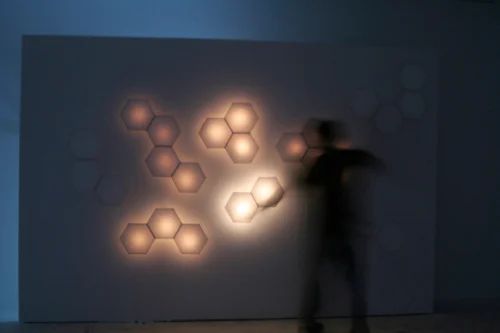 The rice-paper wall, lit and responding to motion.